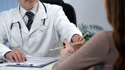 Doctor giving drug prescription to patient, qualified diagnosis and treatment