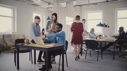 Sticker - Confident woman CEO helping mixed ethnicity male colleagues, looking at laptop screen. Teamwork in modern office 4K.