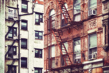 Retro Stylized Picture Of Old Buildings With Fire Escapes, One Of New York City Symbols, USA.