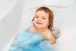 © ulza - Funny child playing with water and foam in a bathroom. child bathes.