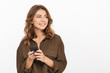© Drobot Dean - Portrait of a smiling young woman holding mobile phone