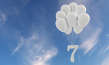Fototapeta  - Number 7 party celebration. Number attached to a bunch of white balloons against blue sky