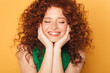 Close up portrait of a smiling curly redhead woman