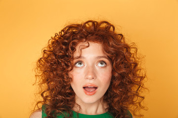 Wall Mural - close up of surprised young curly redhead woman