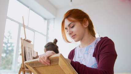 Wall Mural - Young female woman in front of artist draws sketches of woman figure