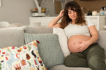 Wall Mural - Pregnant woman touching her belly