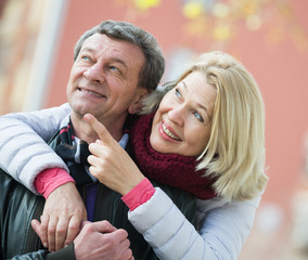 Wall Mural - Senior husband and wife cuddling outdoors