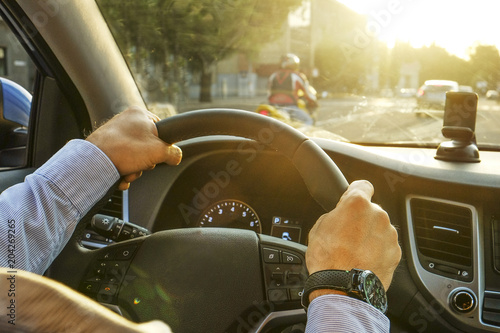Close Up Of Young Man Hands Holding Steering Wheel Driving