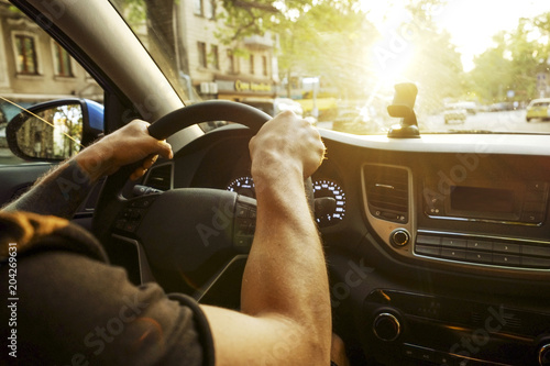 Young Man In Black T Shirt Holding Steering Wheel Driving