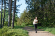 © soleg - young girl walking in spring forest with camera and taking pictures