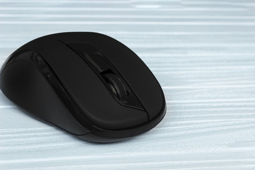 copy spaсe,  computer mouse on a blue, wooden background