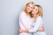 Portrait Of Attractive Trendy Stylish Cute Cheerful Similar Mother And Daughter In Casual Outfit Hugging Isolated Over Grey Background Beaming Smiles