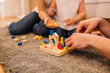 © Nebojsa - Parents with daughter playing wooden puzzle game