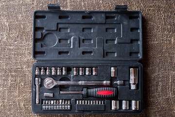 Set of tools with attachments and adapters for twisting nuts and bolts, screws of various configurations