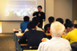 © Daruna - Audience listening speaker who standing in front of the room at the conference hall, Business and Entrepreneurship concept.