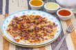 © HeyRix - South Indian Food Uttapam Also Know As ooththappam, Rava Uttapam, Uttapa or Uthappa is a Popular South Indian Delicious Spicy Breakfast Snack Served with Coconut Chutney, Tomato Sauce and Sambar