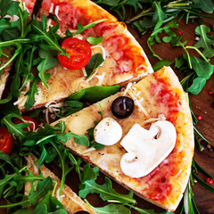 Wall Mural - Hot pizza slice with Pepperoni, melting cheese on a rustic wooden table close up. Top view.