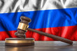 Wooden gavel and flag of Russia on background - law concept