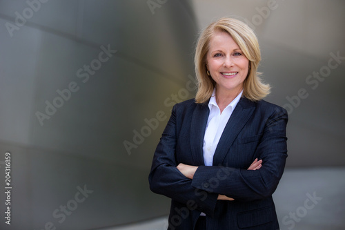 Fotografía Pretty older business woman, successful confidence with arms crossed in financia