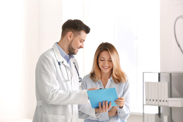 Sticker - Doctor consulting female patient in clinic