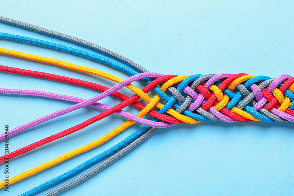 Braided ropes on color background, top view. Unity concept - obrazy, fototapety, plakaty 
