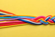 © New Africa - Braided ropes on color background, top view. Unity concept