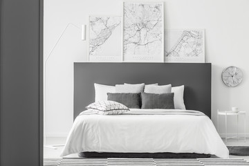 Maps in simple bedroom interior