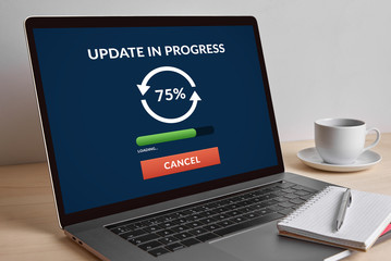 Update concept on modern laptop computer screen on wooden table. All screen content is designed by me. 