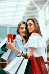 Wall Mural - Shopping. Smiling Women Taking Photos In Shopping Centre