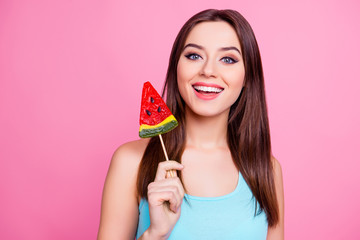 Do you want candy? Portrait of attractive lovely pretty playful funky fancy tender enchantress woman with long silky smooth hair holding a piece on caramel fruit on stick, isolated on pink background