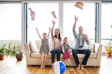 Wall Mural - Young family with two children packing for holiday.