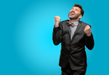 Wall Mural - Middle age man, with beard and bow tie happy and excited celebrating victory expressing big success, power, energy and positive emotions. Celebrates new job joyful