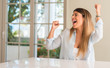 © Krakenimages.com - Young beautiful woman at home happy and excited celebrating victory expressing big success, power, energy and positive emotions. Celebrates new job joyful