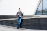 Fototapeta Pomosty - businessman talking on the phone while walking