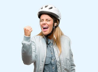 Wall Mural - Young woman with bike helmet and earphones irritated and angry expressing negative emotion, annoyed with someone