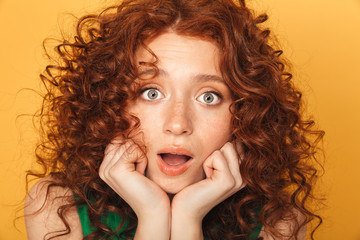Wall Mural - close up portrait of a surprised curly redhead woman