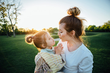 mother hugs her dauhter.