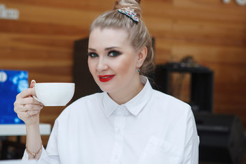 Beautiful Young cute woman smiling and looking at camera in cafe