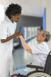 © JPC-PROD - Careful female caregiver or nurse helping senior woman to stand up