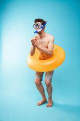 Full length portrait of a cheerful young shirtless man