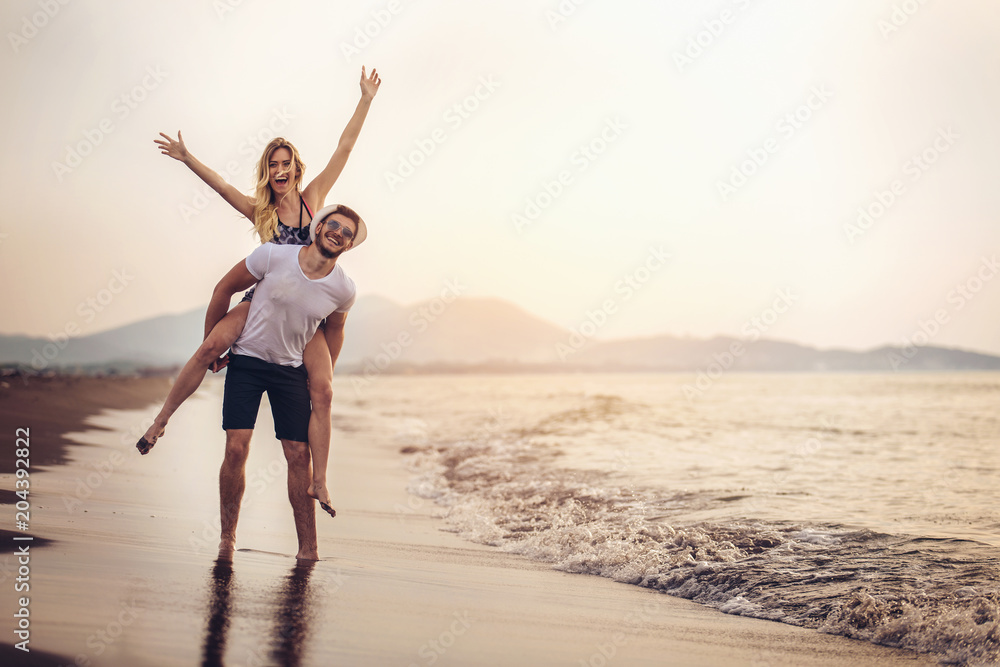 Happy couple in love on beach summer vacations. Joyful girl ...
