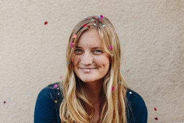 Blonde tossing confetti in celebration