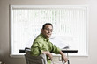 © Mint Images - Business owner sitting at his design desk in office