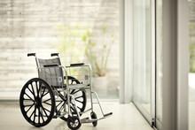 Empty Wheelchair In A Home Interior.