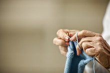 Close-up Of Elderly Woman's Hands As She Knits.
