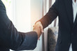 © thithawat - attractive business man hand shaking for complete business deal together successful. teamwork concept. partnership concept and dealership concept.