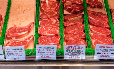 A group of assorted beef steaks at a market