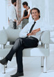 © ASDF - smiling businessman sitting in office chair
