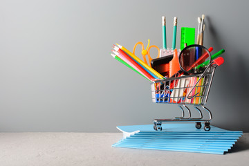 Wall Mural - Shopping cart with stationery on notebooks