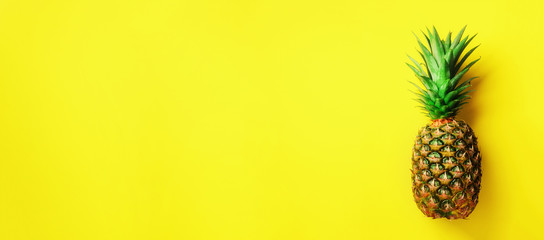 Wall Mural - pineapple on yellow background. top view. copy space. pattern for minimal style. pop art design, cre